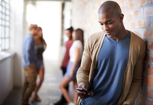 Making plans Shot of a young man sending a text message