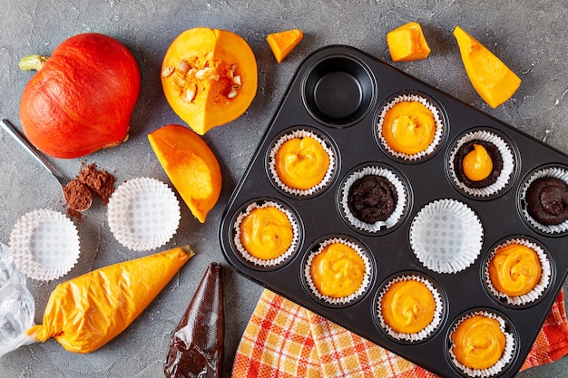 Preparare muffin alla zucca per la festa di halloween. ingredienti sullo sfondo, vista dall'alto