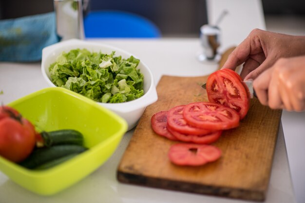 Making salad for lunch in modern kitchen