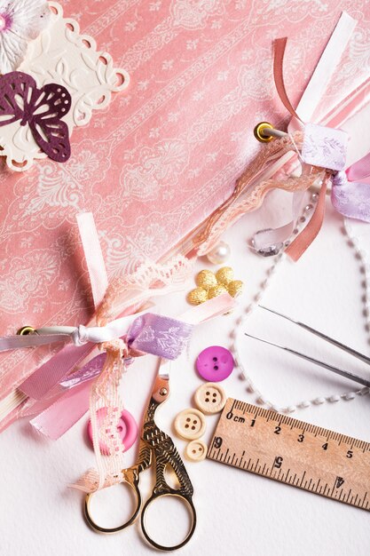 Photo making scrapbooking album with rings and decorations on the table and tools