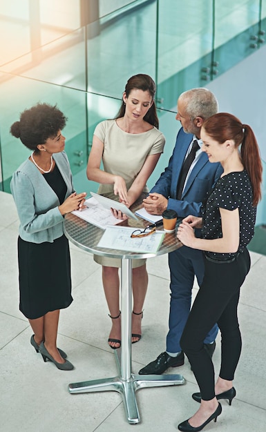 Making some big business decisions together shot of a group of businesspeople working together on a digital tablet in an office