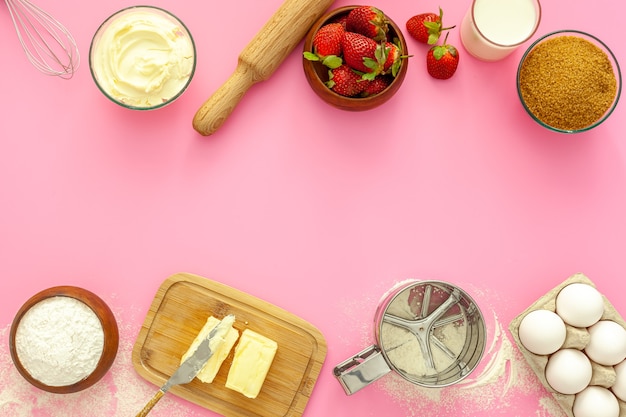 Making strawberry pie. Products for the pie are flour, sugar, butter and strawberries.