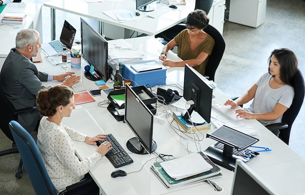 making success one project at a time shot of a group of coworkers sitting at their workstations in an office