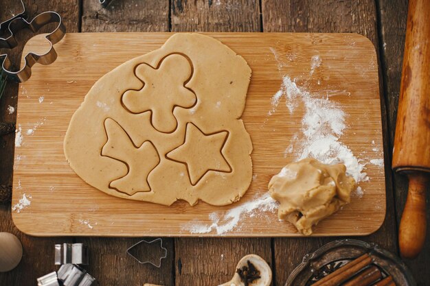 Making traditional christmas gingerbread cookies on rustic table Top view Gingerbread dough