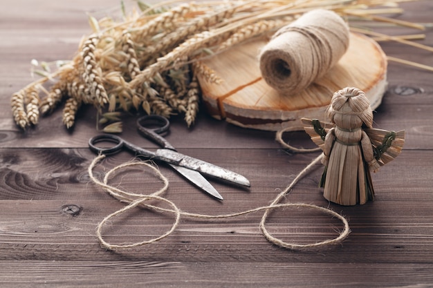 Making traditional straw toy angel with wing