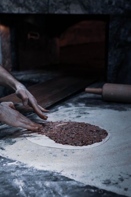 Making a turkish pizza or lahmacun fast food and popular street food in Mediterranean countries