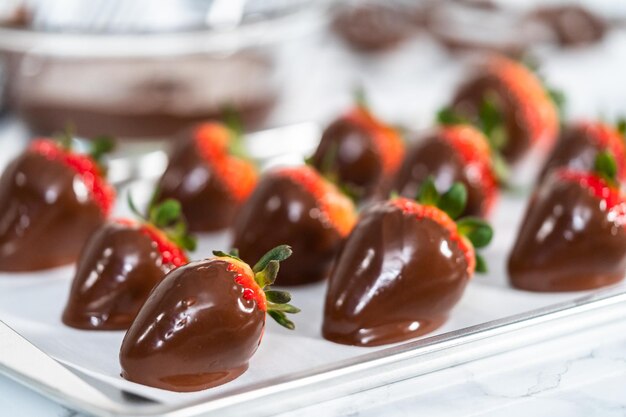 Making white and dark chocolate dipped strawberries.