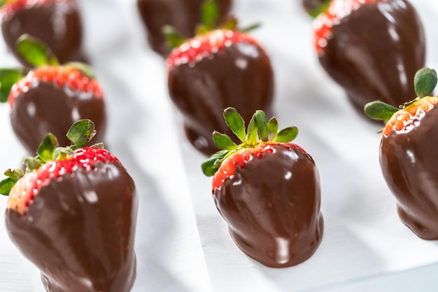 Making white and dark chocolate dipped strawberries.