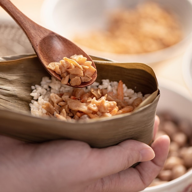 Making zongzi food preparing and wrapping Chinese rice dumpling at home for Duanwu Dragon Boat Festival celebration lifestyle