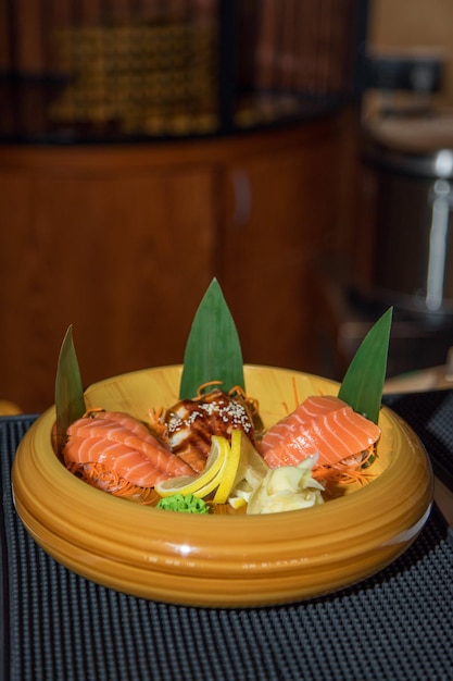 Makizushi food and soup gentleman in sushi asian gastronomic\
food composition on wooden table