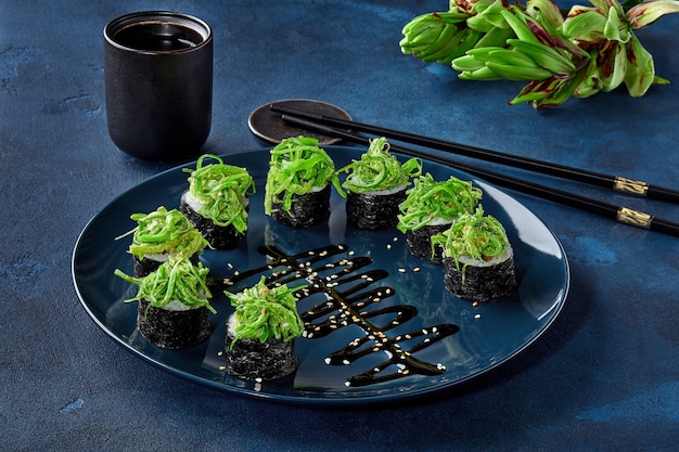 Makizushi rolls with wakame seaweed asparagus bell pepper nut sauce