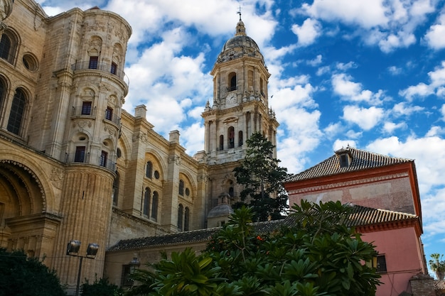 Malaga city cathedral with its main tower in cloudy day and blue sky.