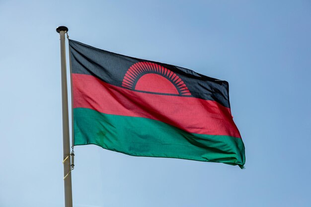 Malawische vlag wappert tegen een strakblauwe lucht