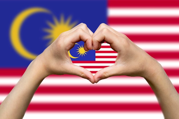 Photo malaysia flag with two hands heart shape patriotism and nationalism idea hand heart love sign