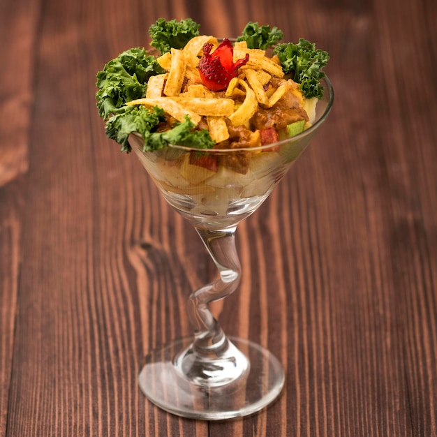 ストロベリー チキン スライスと緑の葉のマレーシア サラダ テーブル トップ ビュー グリーン フードに分離された皿で提供しています
