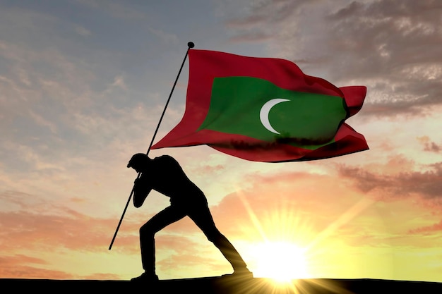 Maldiven vlag wordt in de grond geduwd door een mannelijk silhouet 3D Rendering
