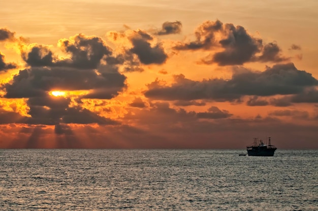 Maldives A boat in the ray lights of sunset Turquoise Tropical  Paradise