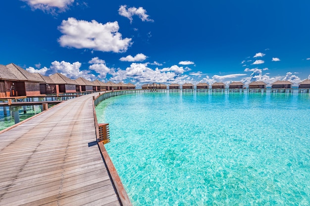 Maldives, dream trip, beautiful sunny luxury exotic vacations. Wooden pier pathway, water villas