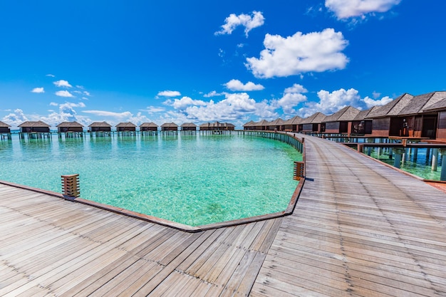 Maldives paradise vacation. Tropical aerial landscape, seascape with long pier, water villas