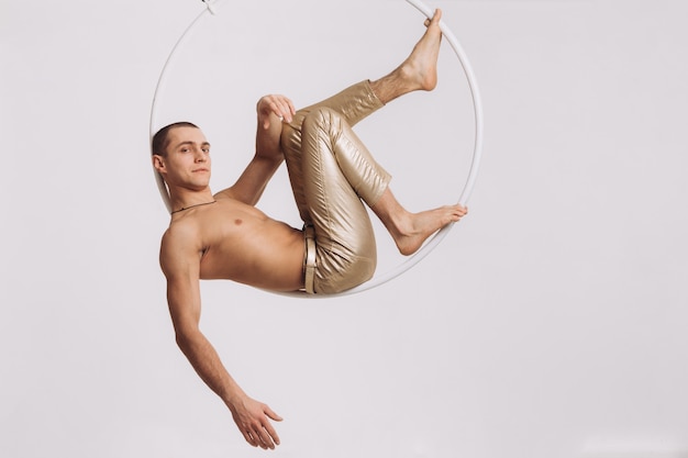 Photo male aerial gymnast performs acrobatic element in the ring