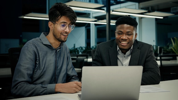 Male african indian colleagues workers men happy business people businessman laughing looking at