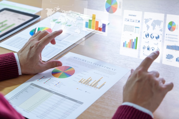 Male analyst touching twin-bar chart on virtual screen