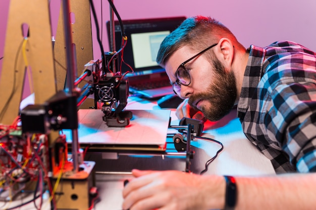 Male architect using printer in office.