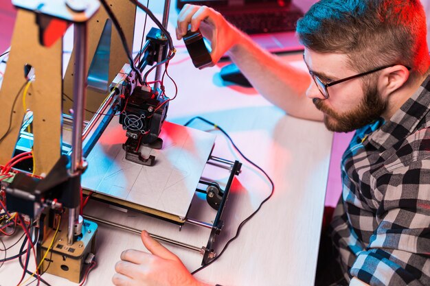 Male architect using printer in office.