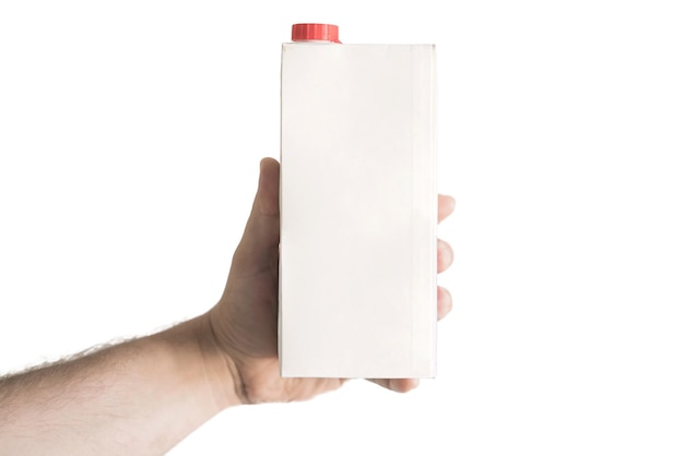 Male arm holds a white blank paper package of milk with red cap Nutrition Copy space Mockup Mock up Paper Design Empty