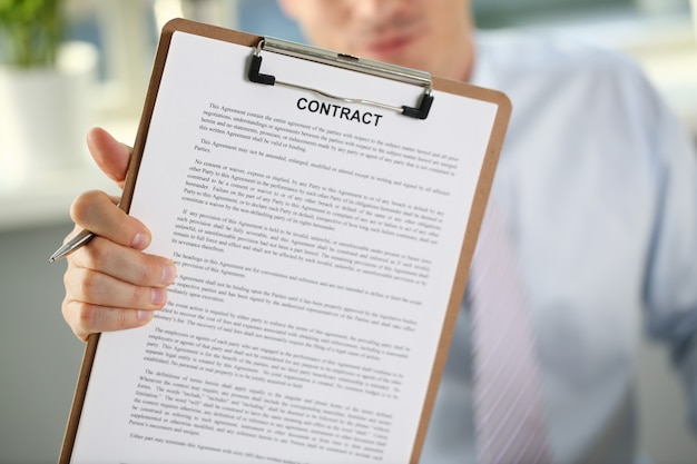 Male arm in suit offer contract form on