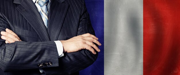 Photo male arms crossed on france flag background