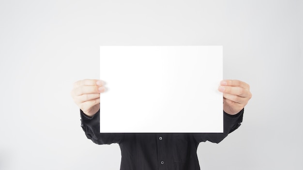 Male asian hold blank paper and wear black shirt on white background.