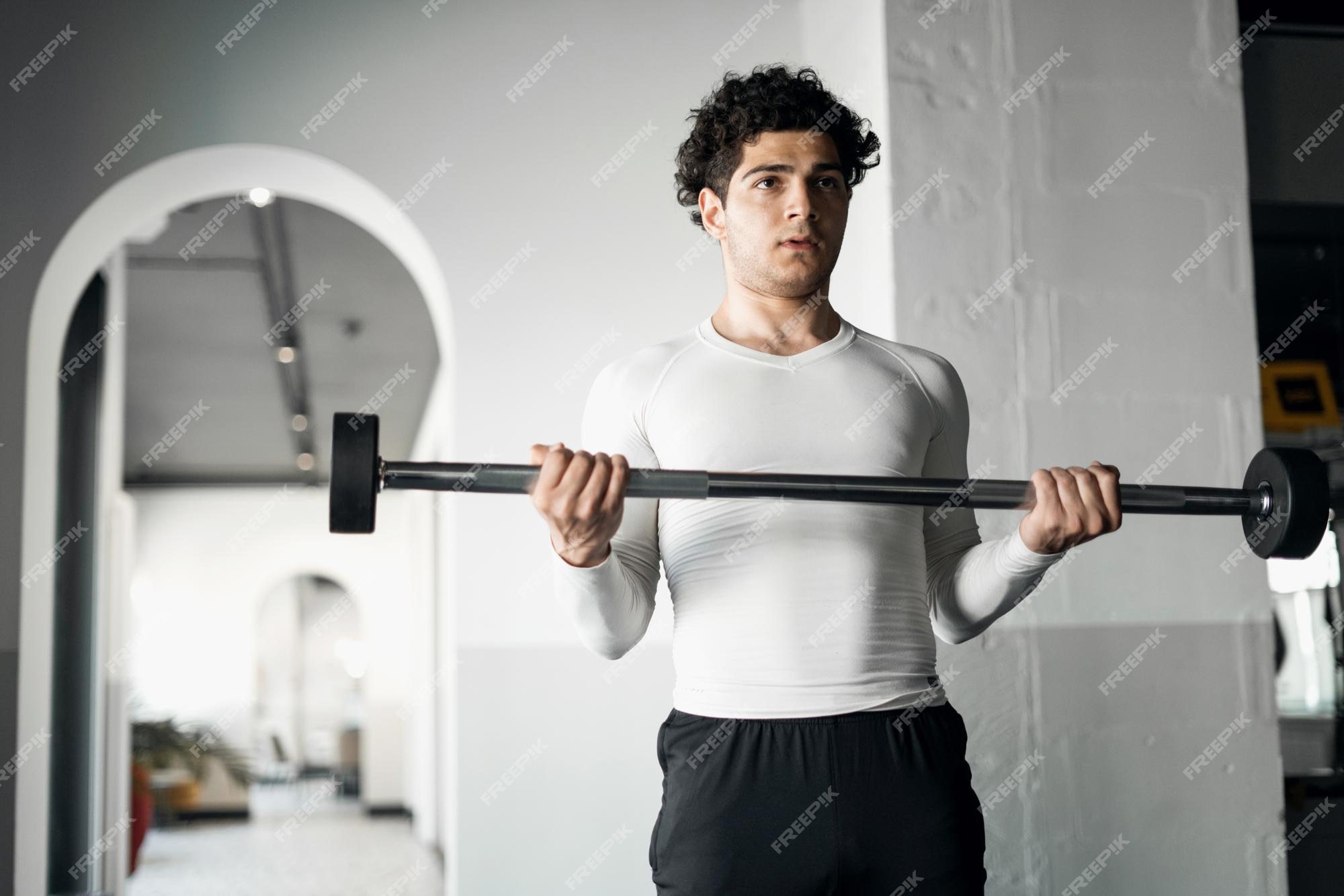 Premium Photo | A male athlete does cardio exercises training in the gym