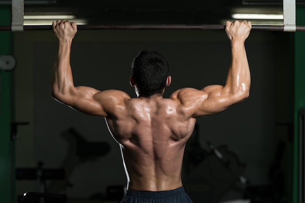 Male Athlete Doing Pull Ups  Chin Ups In The Gym