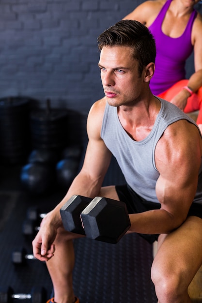 Male athlete exercising with dumbbell