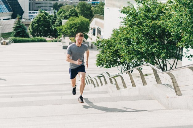 Male athlete jogging on staircase