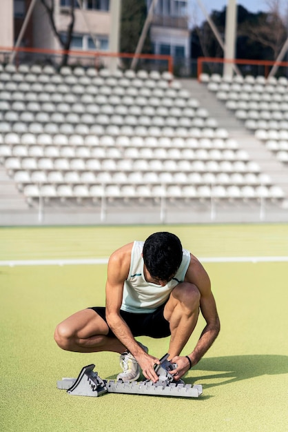 写真 外で座っている男性アスリート