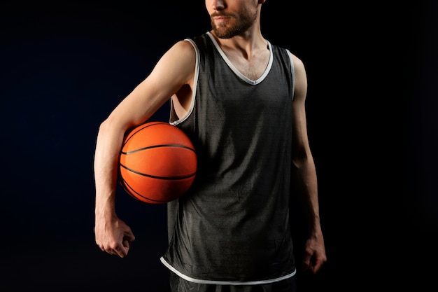 Male athlete with basketball posing