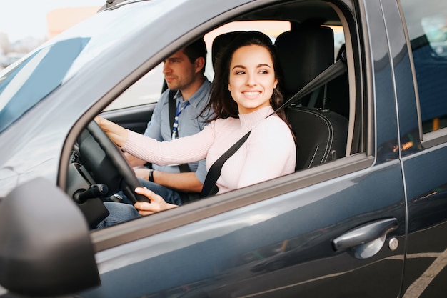 Male auto instructor takes exam with young woman