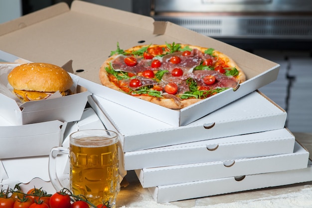 Male baker preparing pizza for delivery