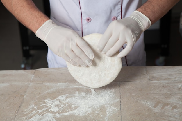 Male baker preparing pizza