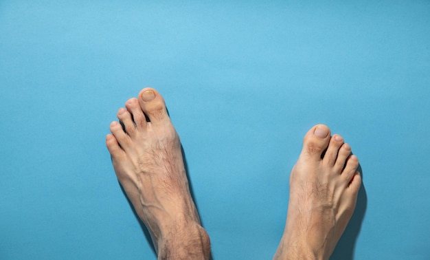 Male barefoot on the blue background