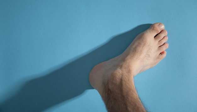 Male barefoot on the blue background