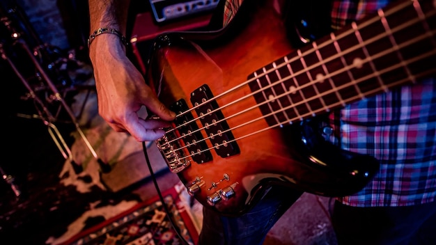 A male bass player plays a bass during a live performance