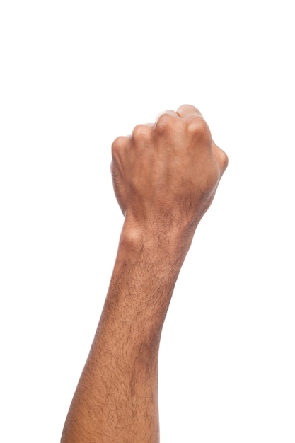 Male black fist isolated on white background. African american clenched hand, gesturing up. Counting, aggression, brave, masculinity concept