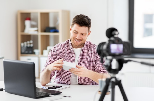 male blogger with camera videoblogging at home