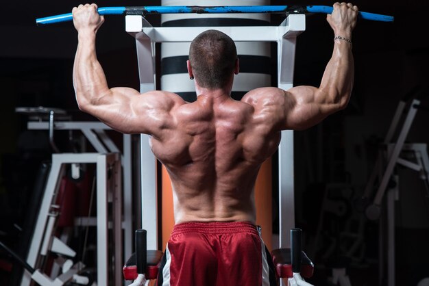 Male Bodybuilder Doing Heavy Weight Exercise For Back