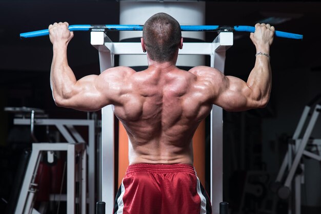 Male Bodybuilder Doing Heavy Weight Exercise For Back