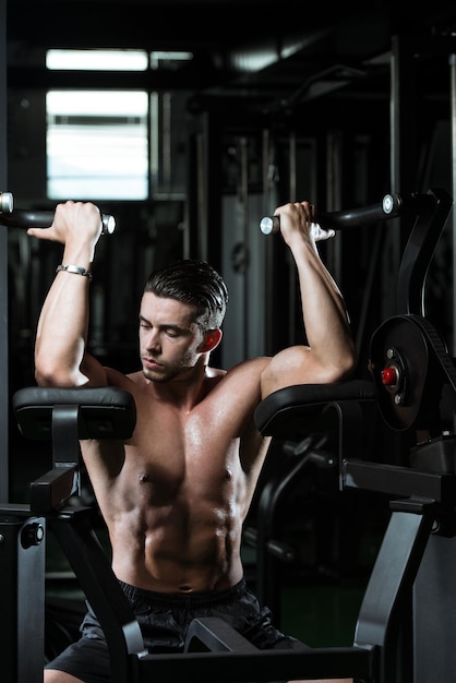 Male Bodybuilder Doing Heavy Weight Exercise For Biceps