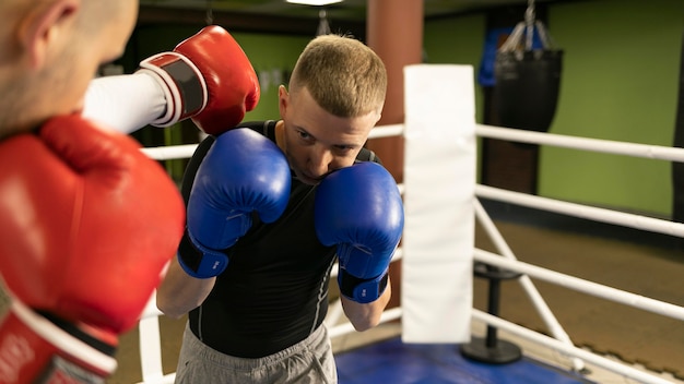 Male boxer practicing in the ring